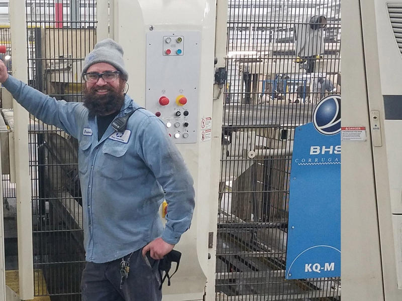 a man standing next to a machine