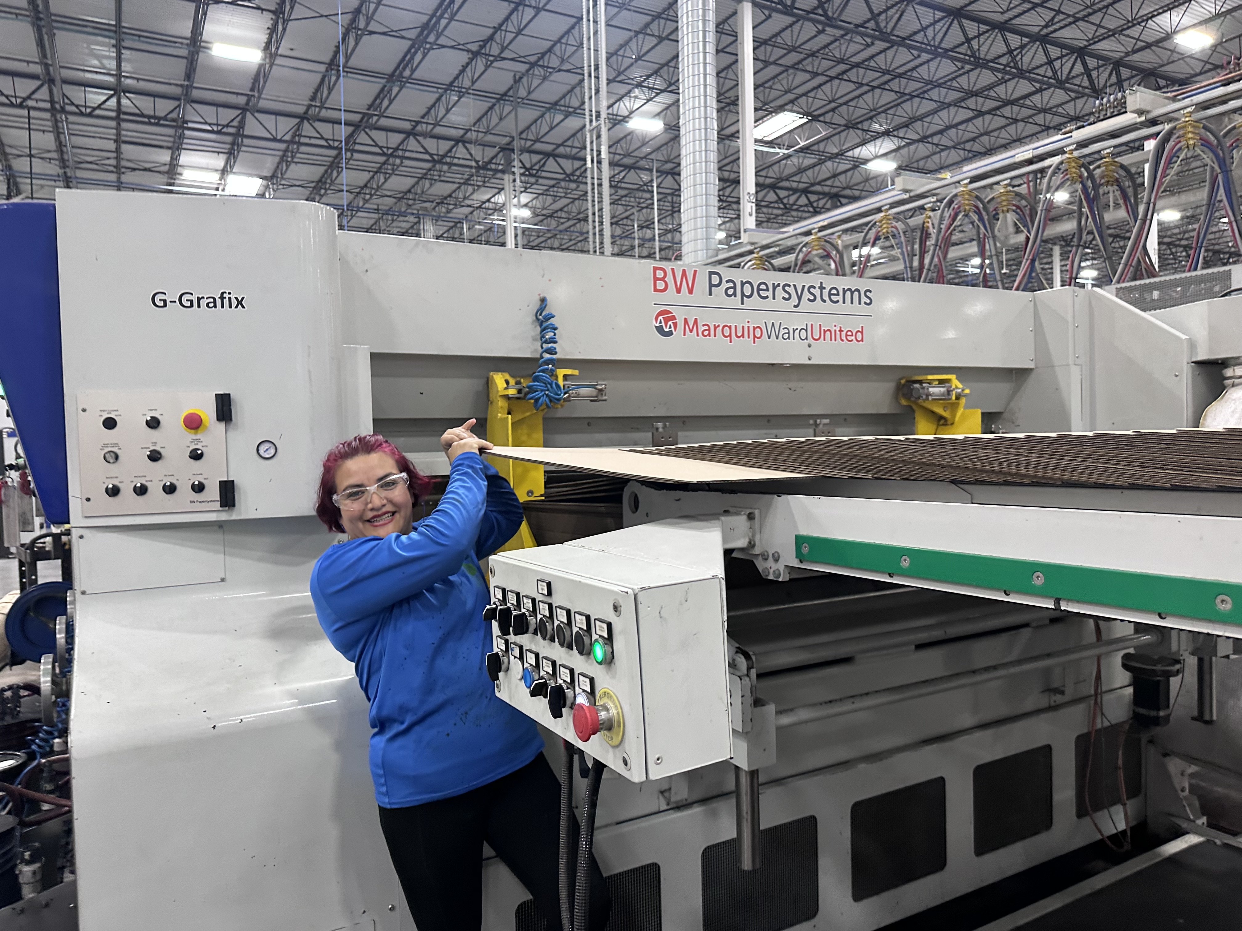 a woman standing next to a machine