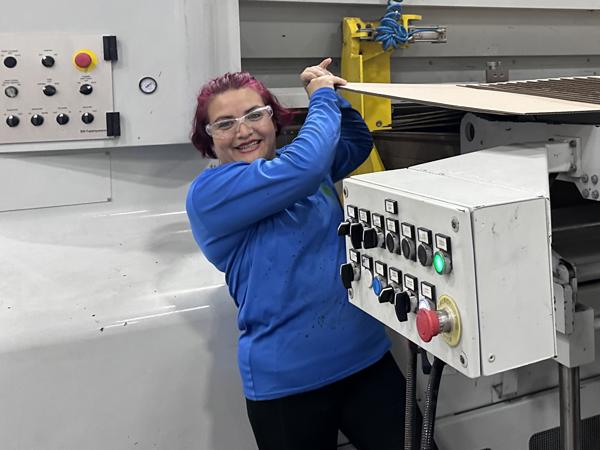 a woman standing next to a machine