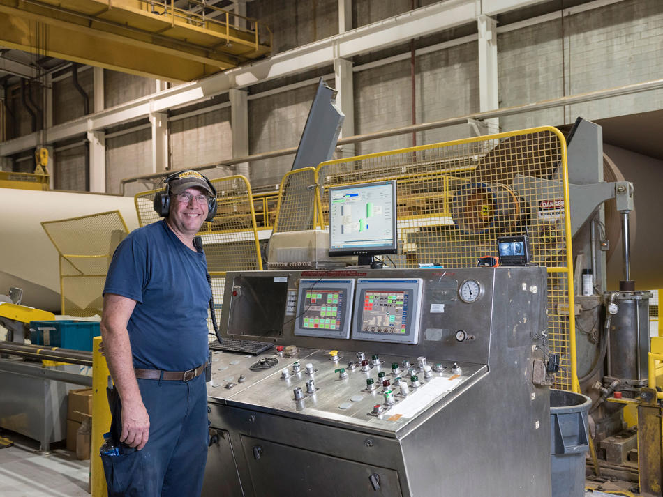 a man standing next to a machine
