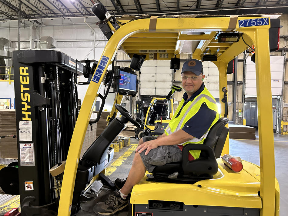 a man sitting in a forklift