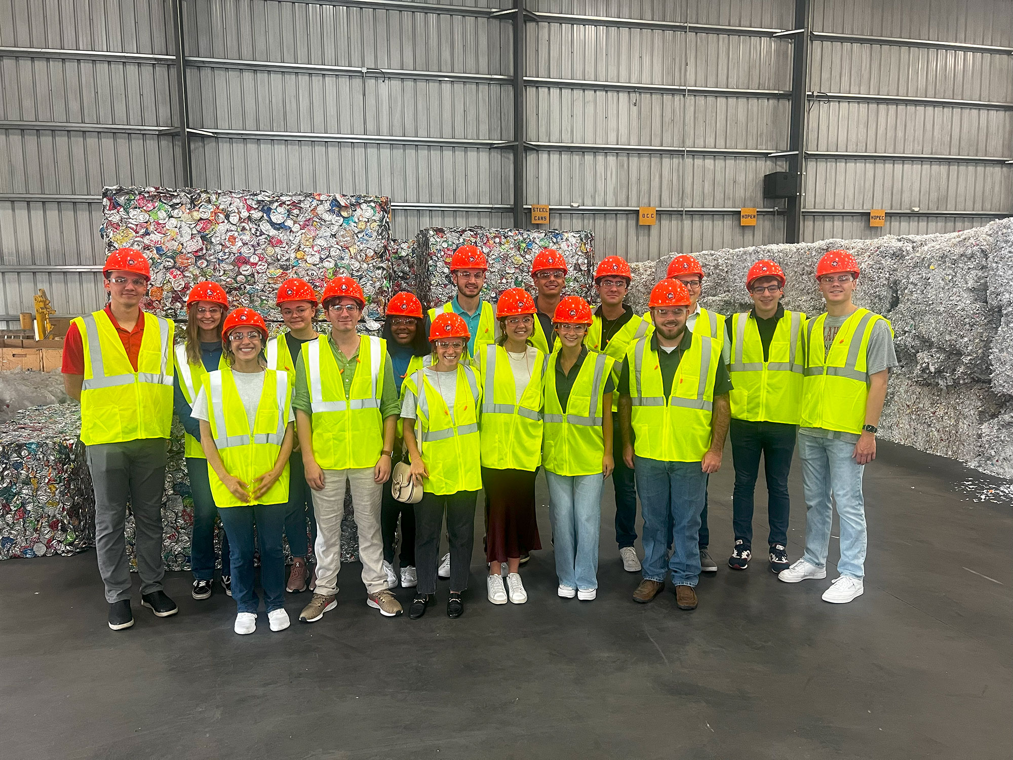 a group of people wearing safety vests and helmets