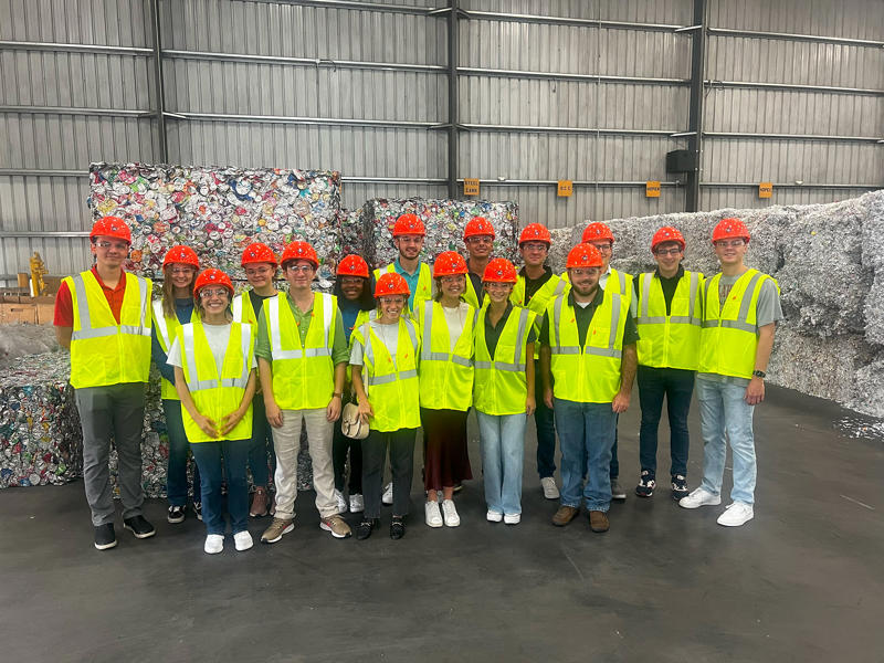 a group of people wearing safety vests and helmets