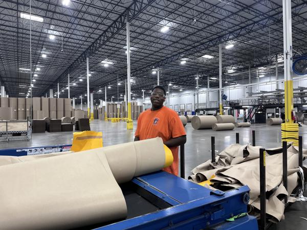 a man standing next to a machine