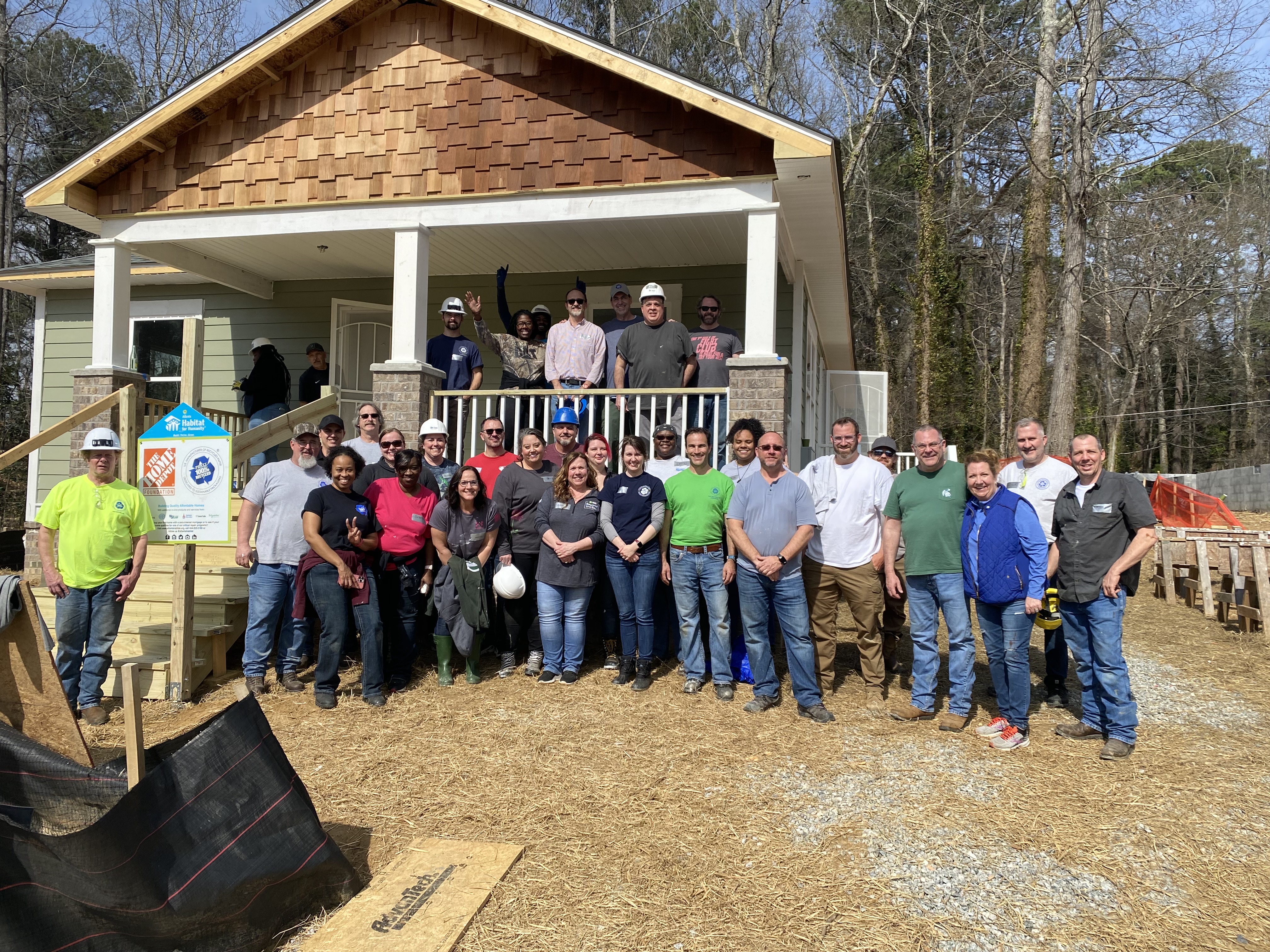 a group of people standing in front of a house