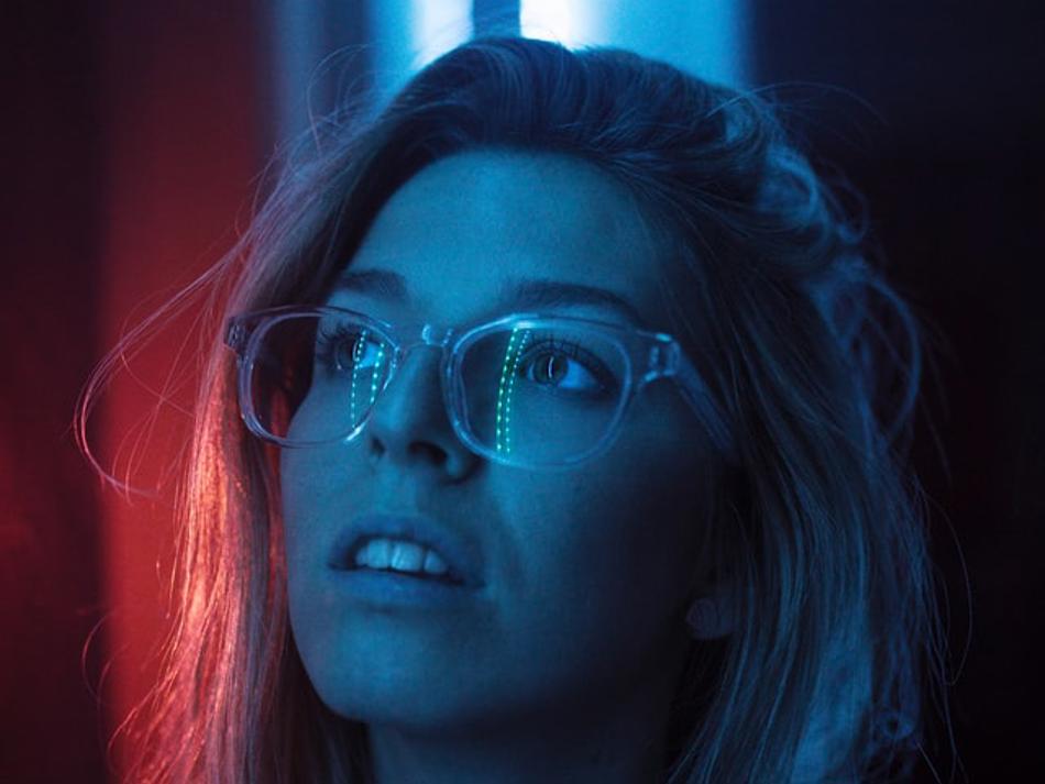 a woman looking up with a blue and red light