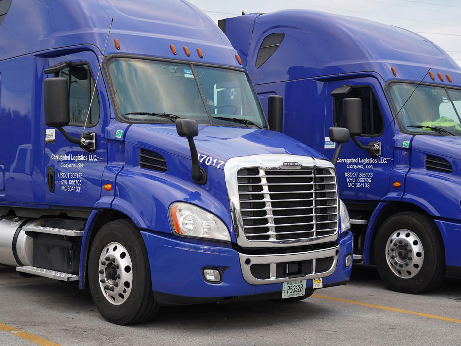 a blue semi trucks parked on the side of the road