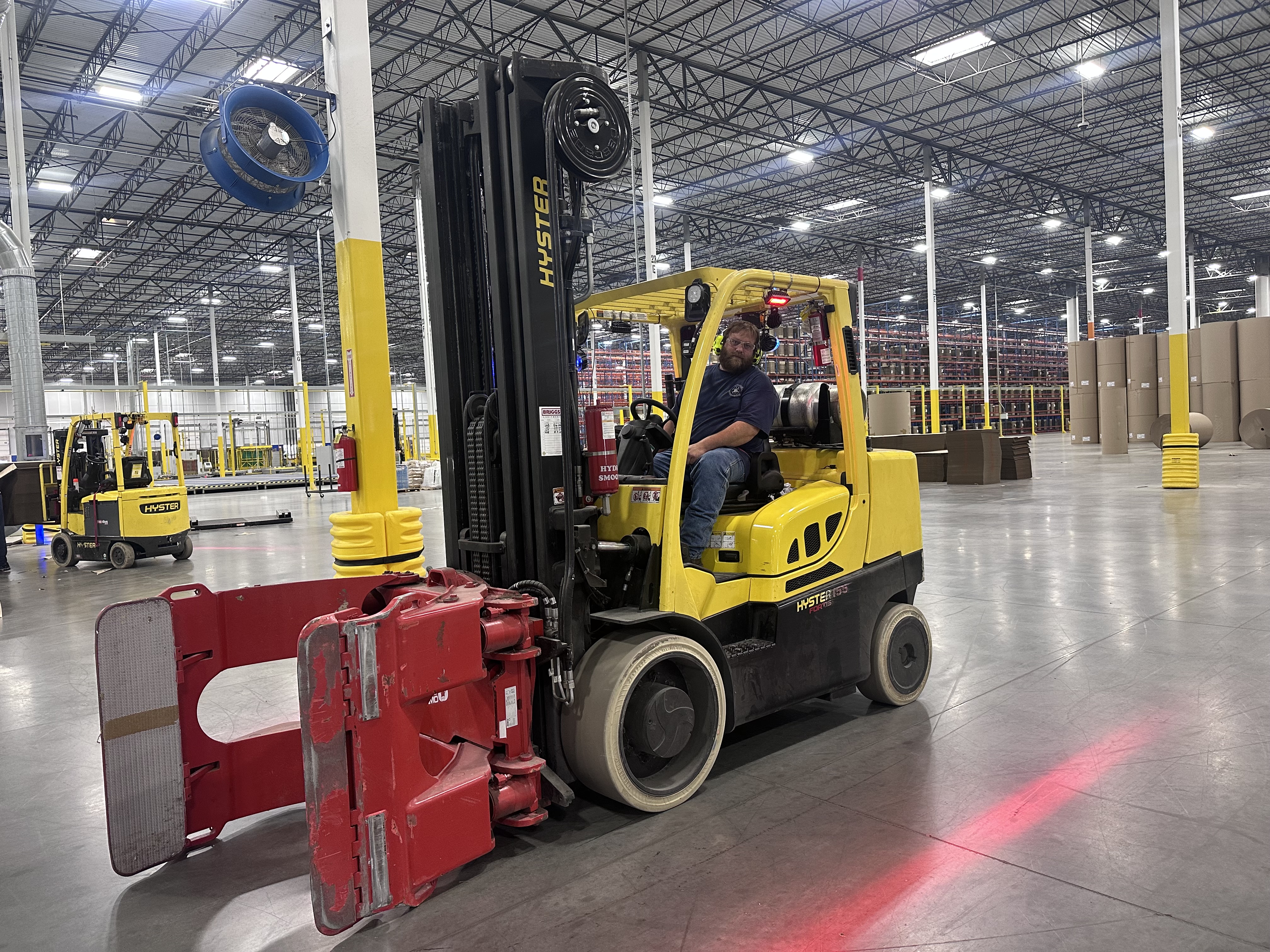 a man driving a forklift in a warehouse