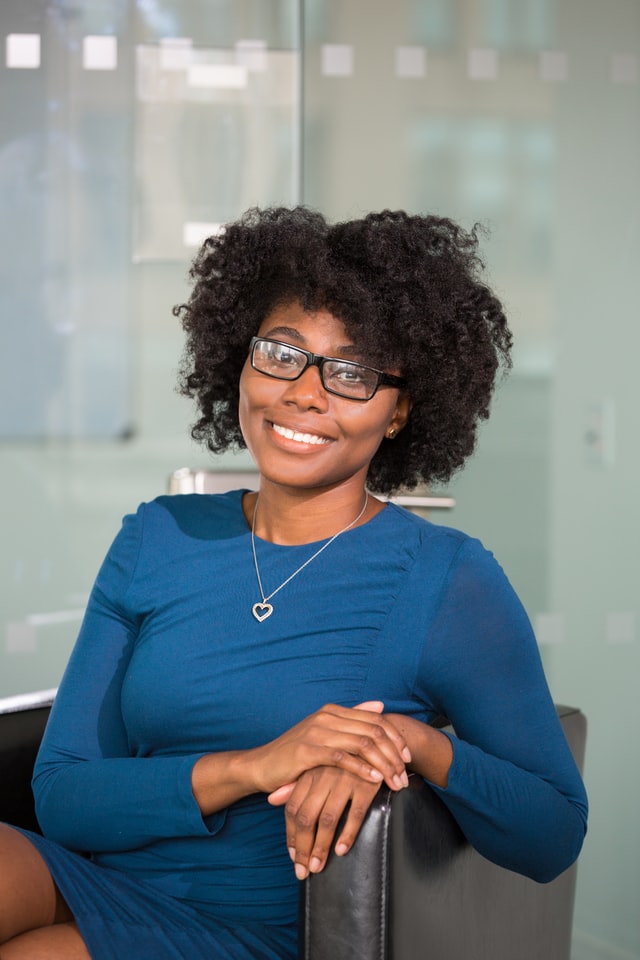a woman wearing glasses and a blue shirt