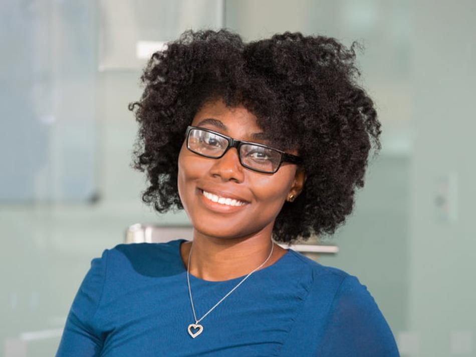a woman wearing glasses and a blue shirt