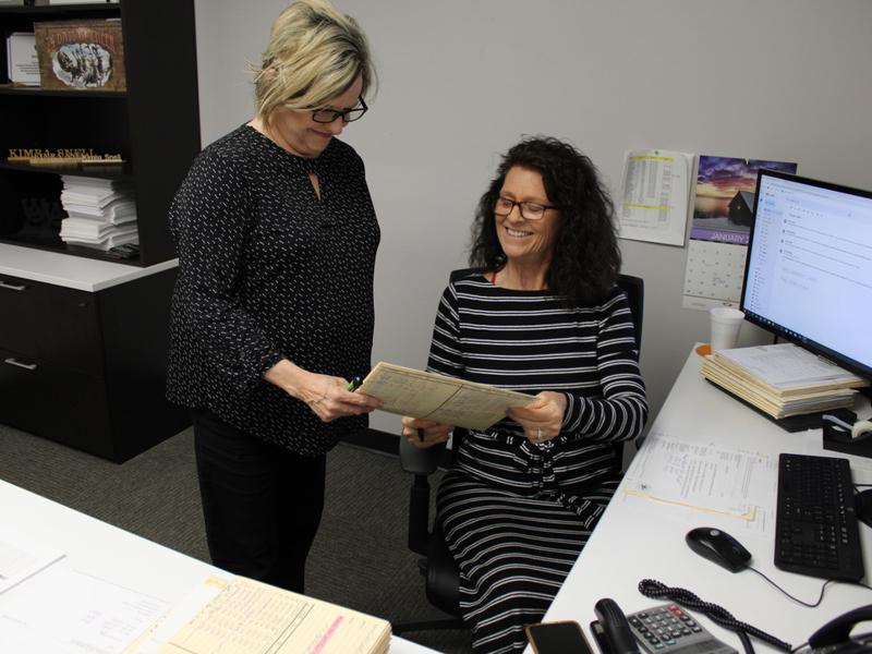 two women looking at a piece of paper