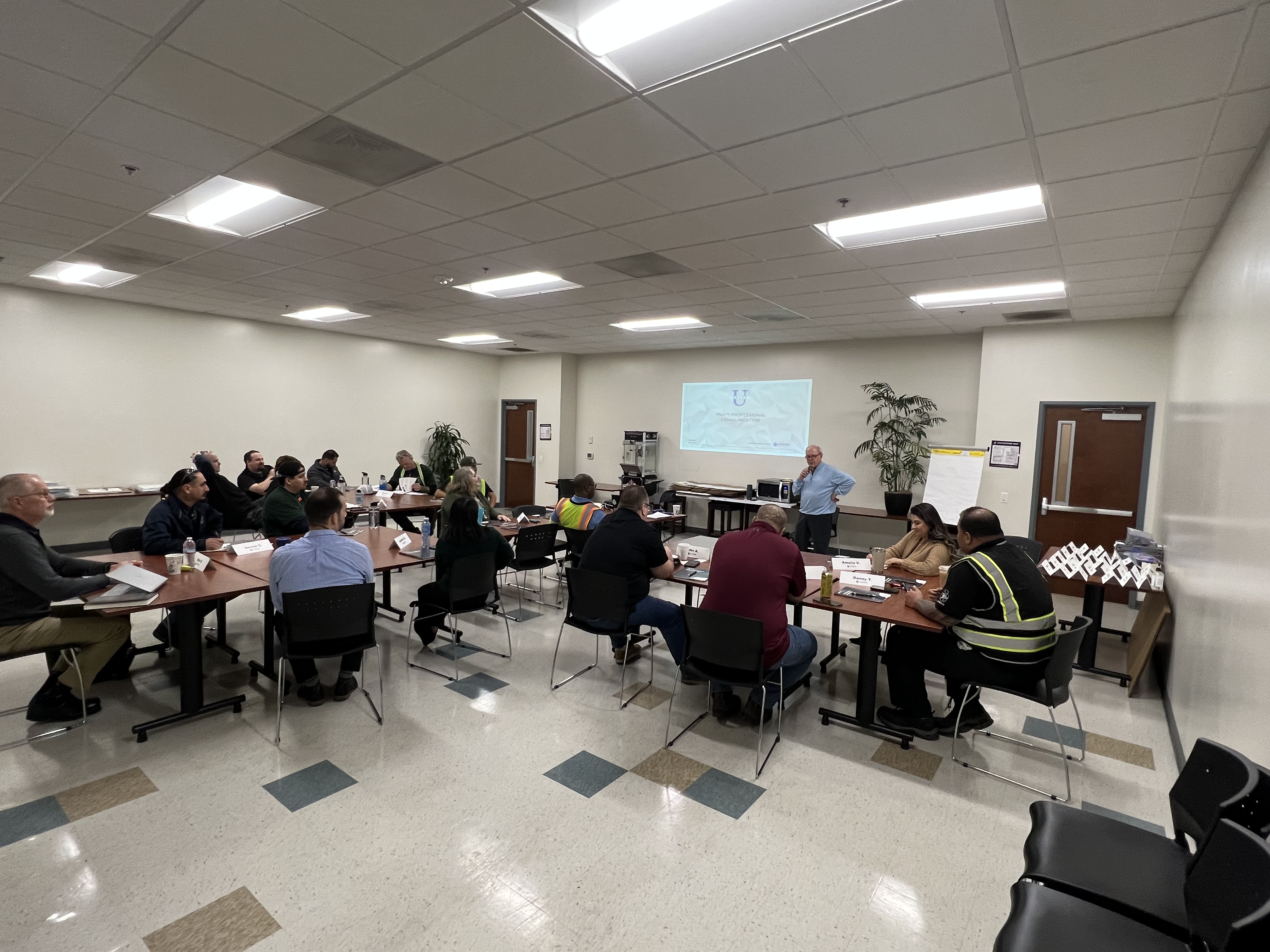 a group of people sitting around tables in a room