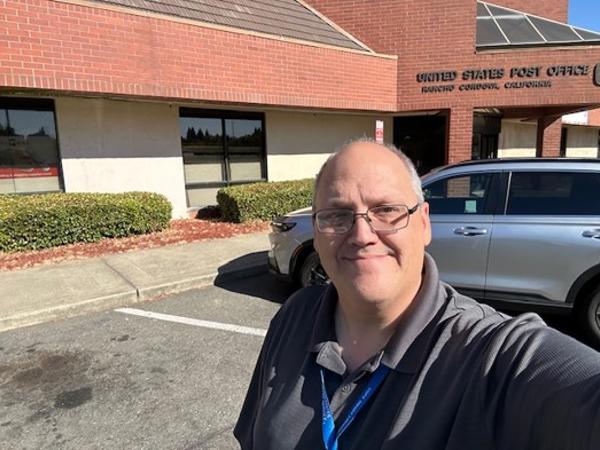 a man taking a selfie in front of a building
