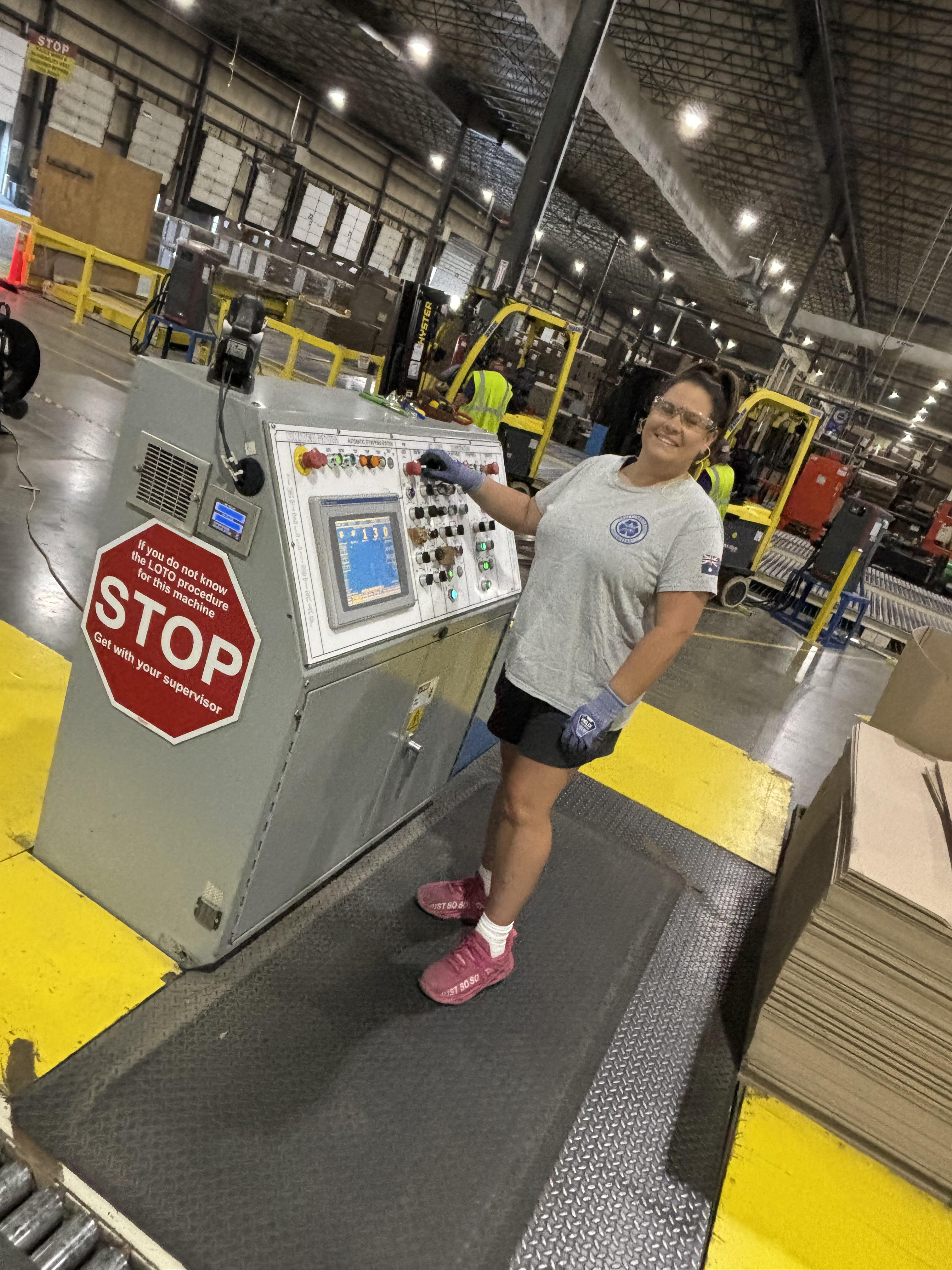 a woman standing next to a machine