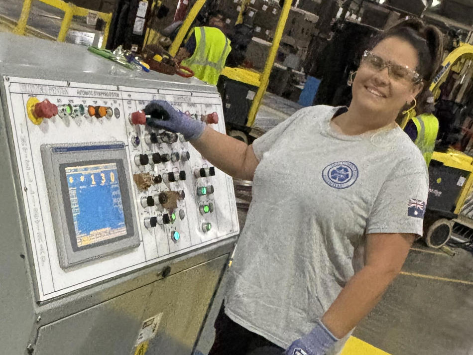 a woman standing next to a machine