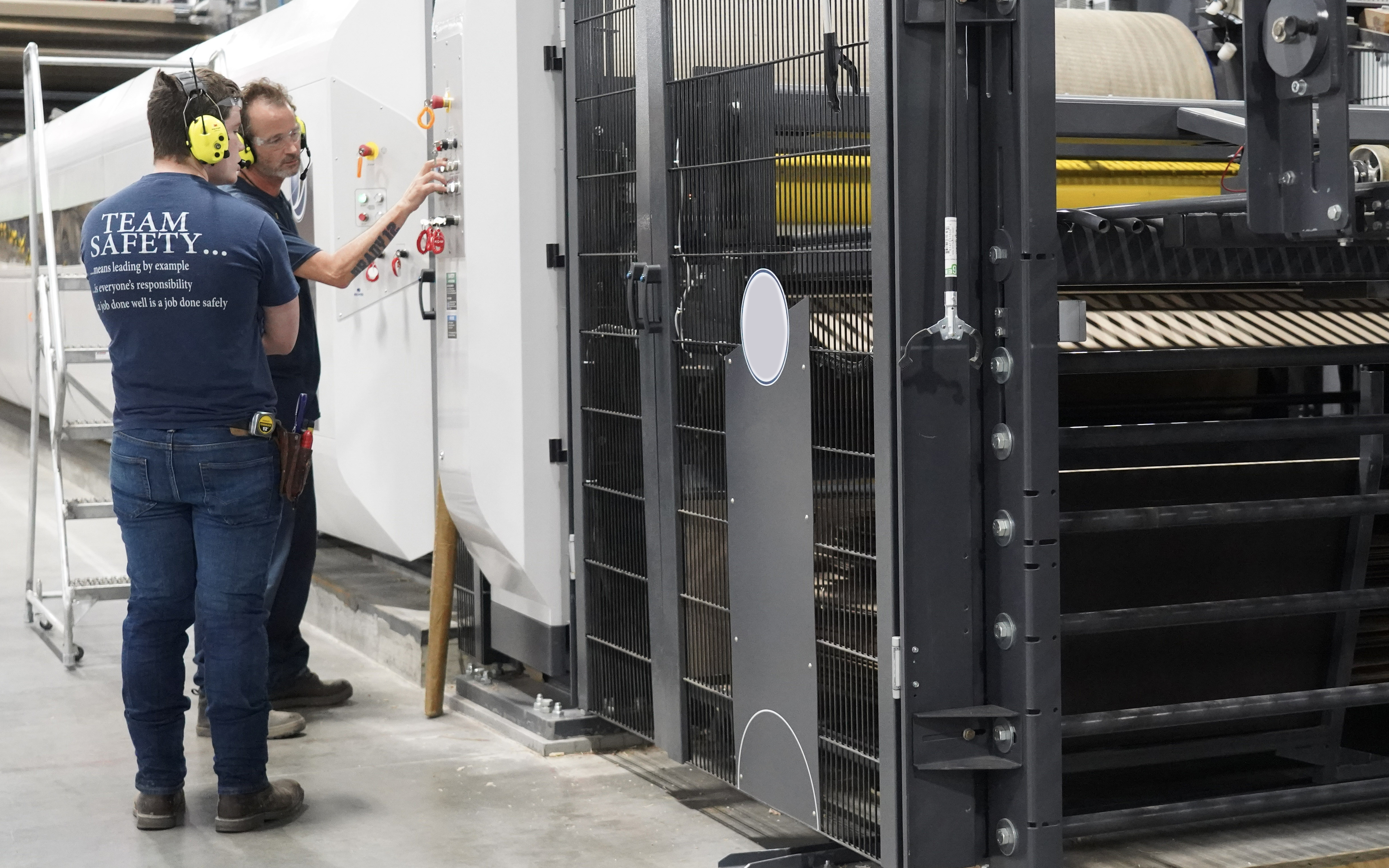 a man standing next to a machine