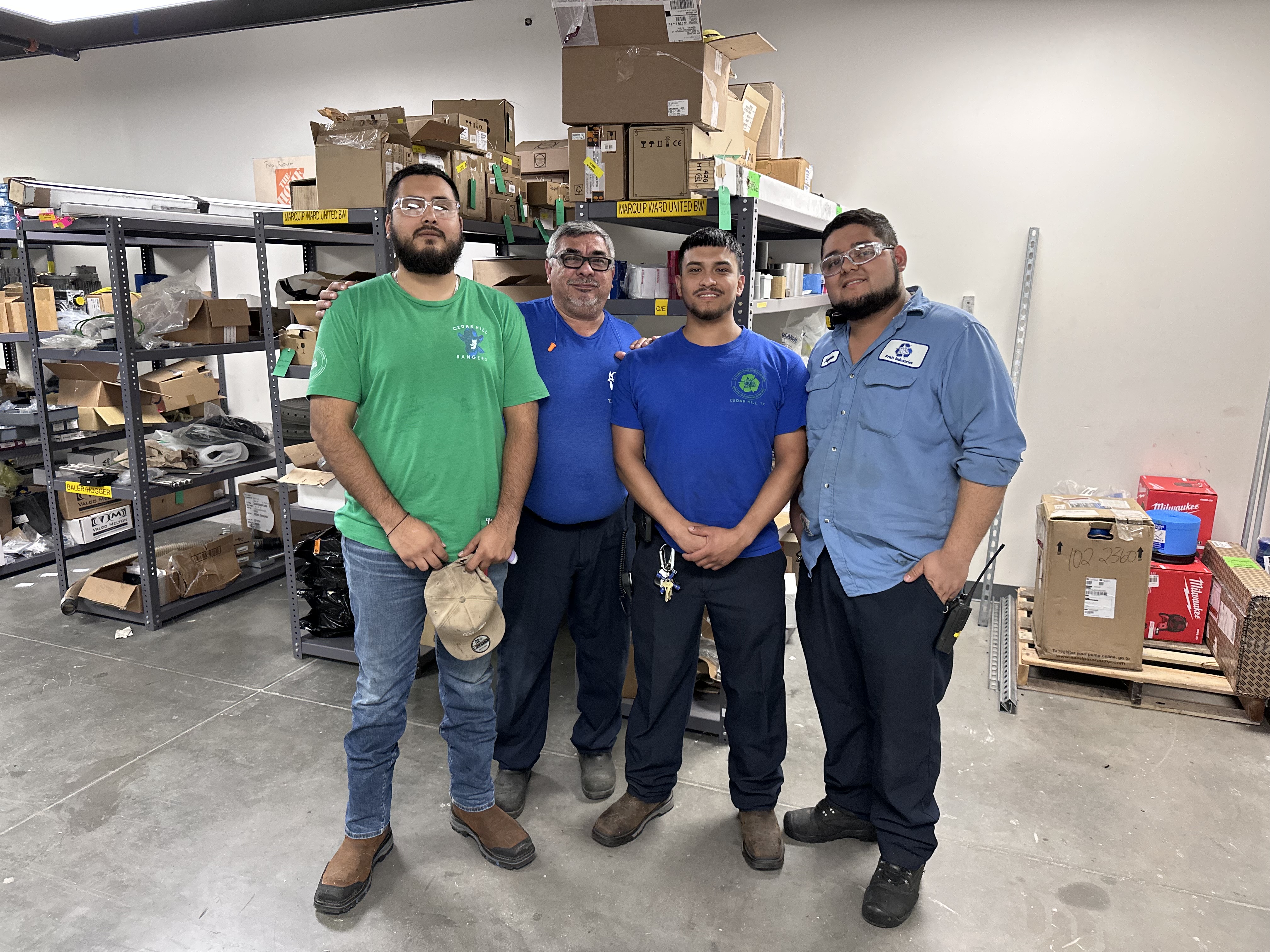 a group of men standing in a warehouse