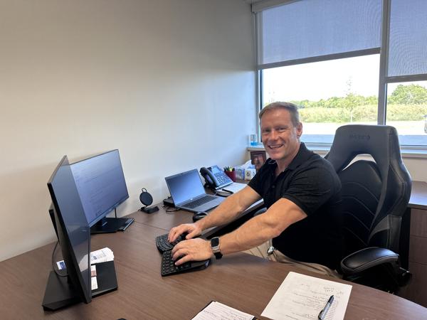 a man sitting at a desk with a computer