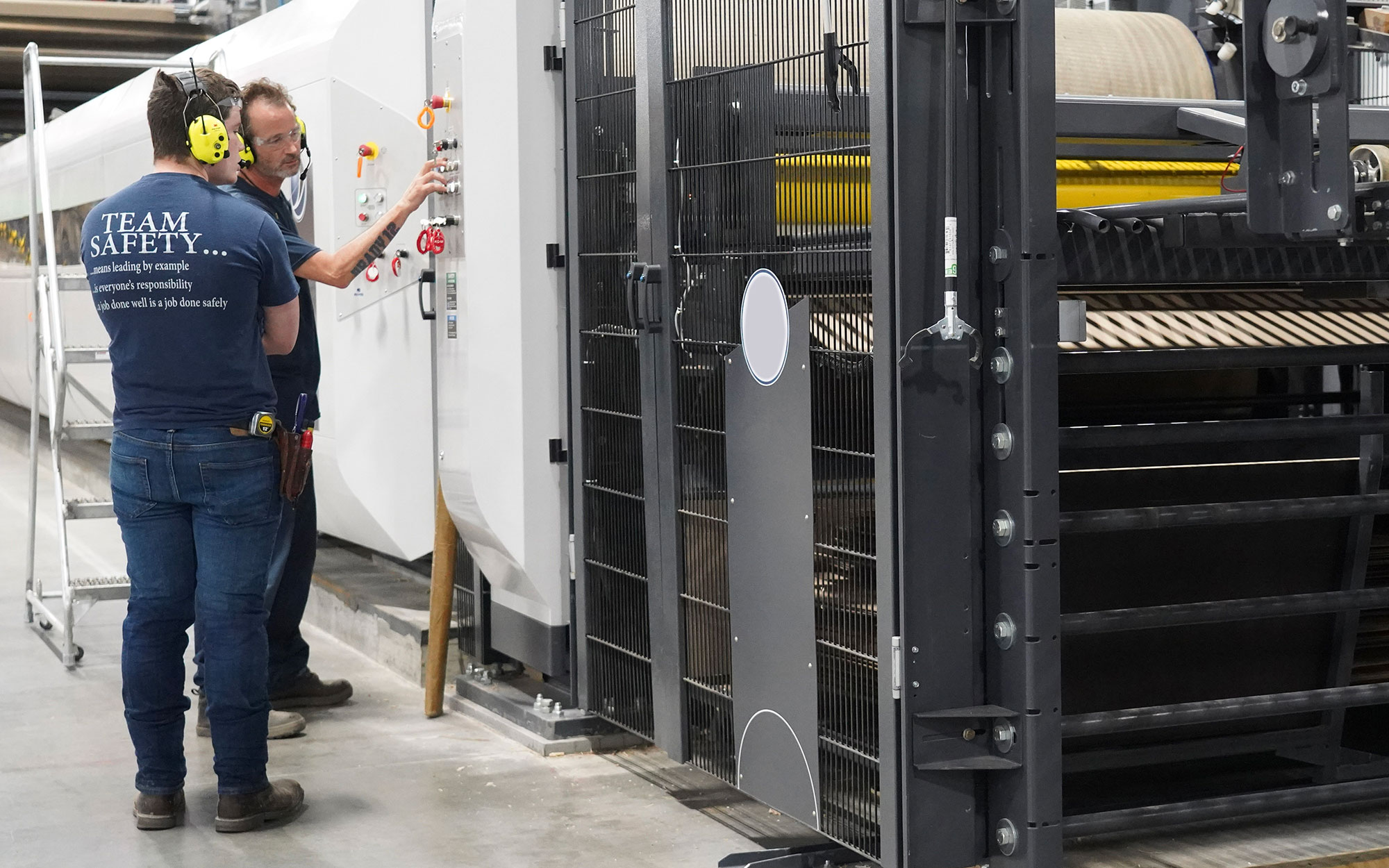 a man standing next to a large machine
