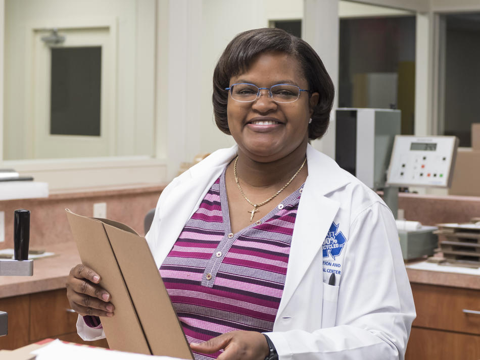 a woman in a lab coat holding a clipboard