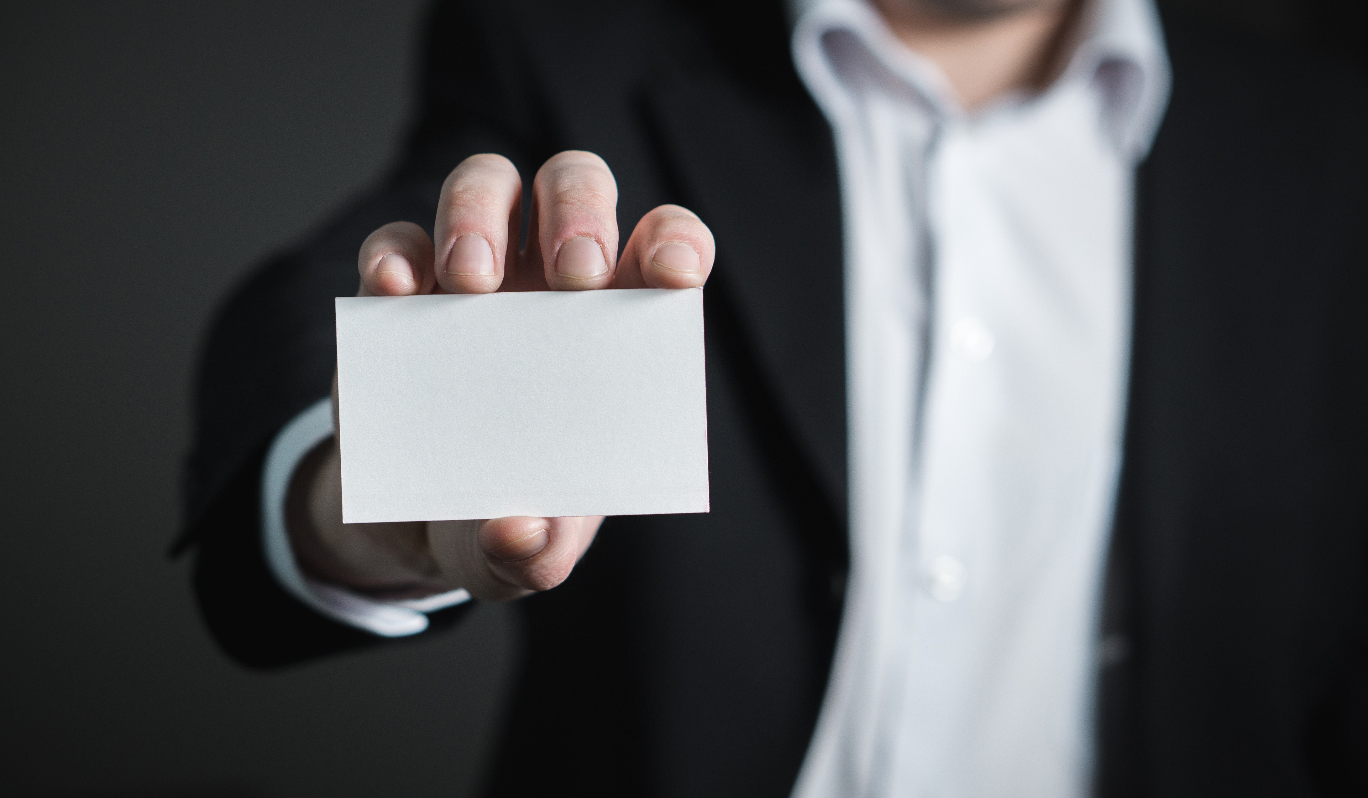 a person holding a white card