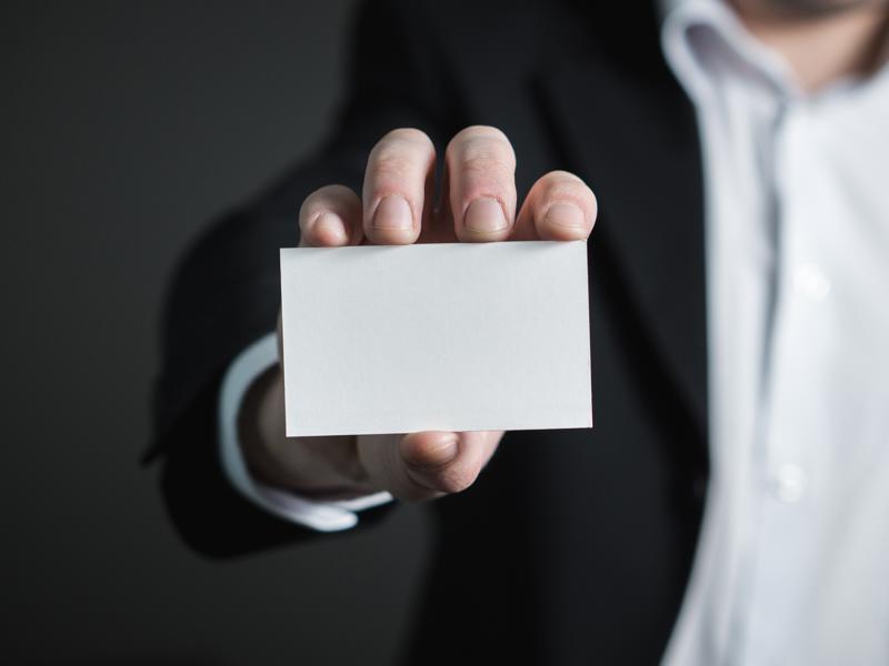 a person holding a white card