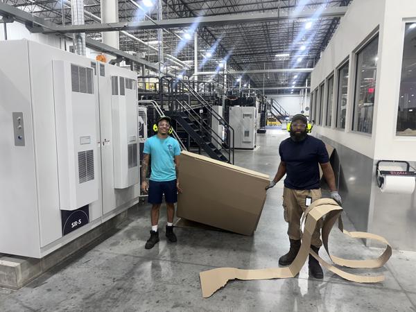 two men standing in a warehouse
