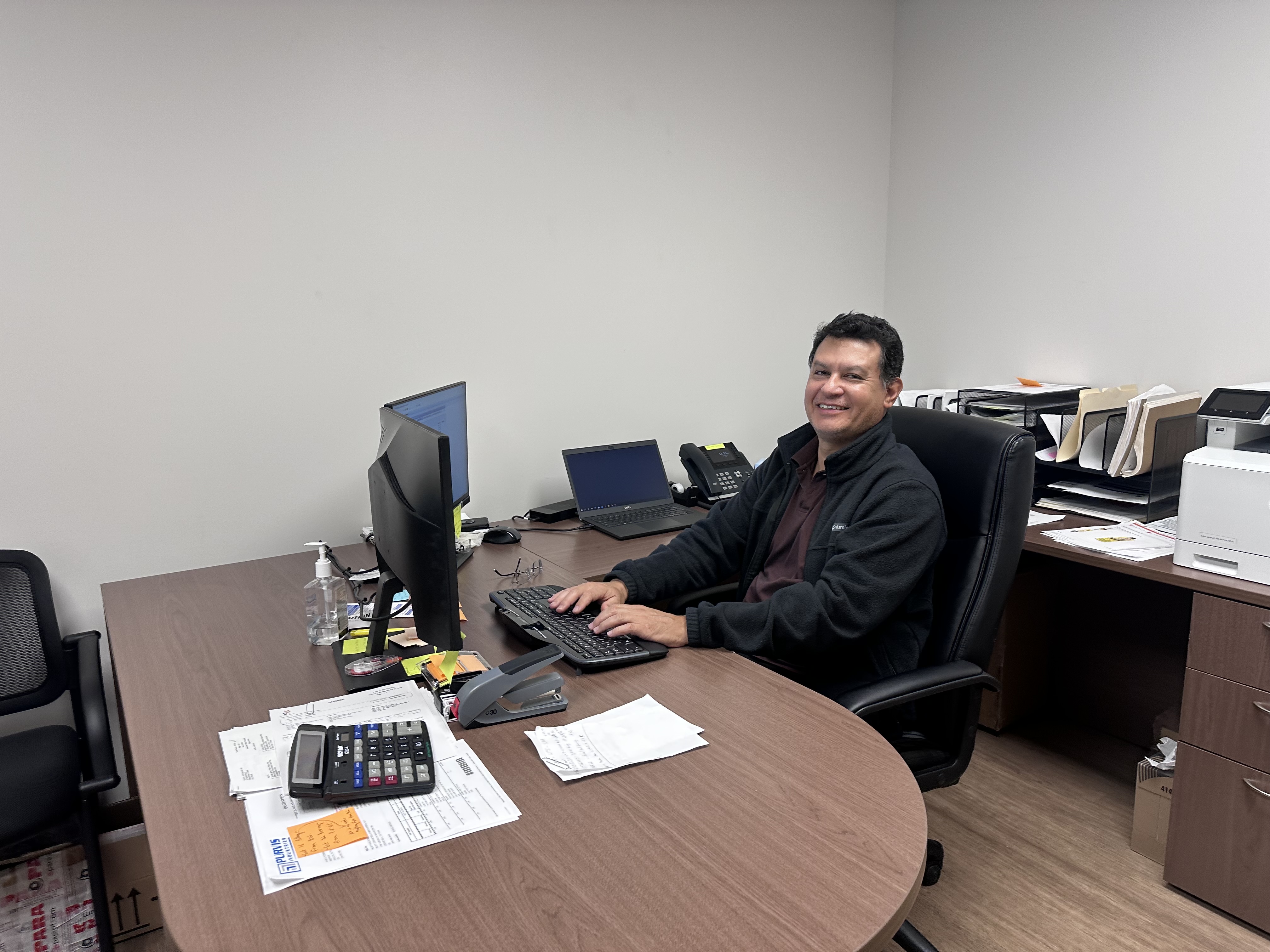 a man sitting at a desk with a computer