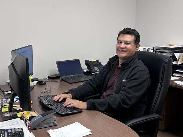 a man sitting at a desk with a computer