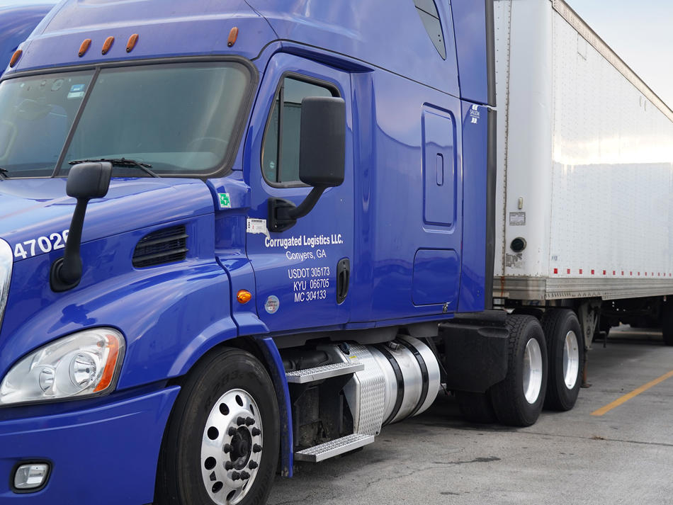 a blue semi truck with a trailer