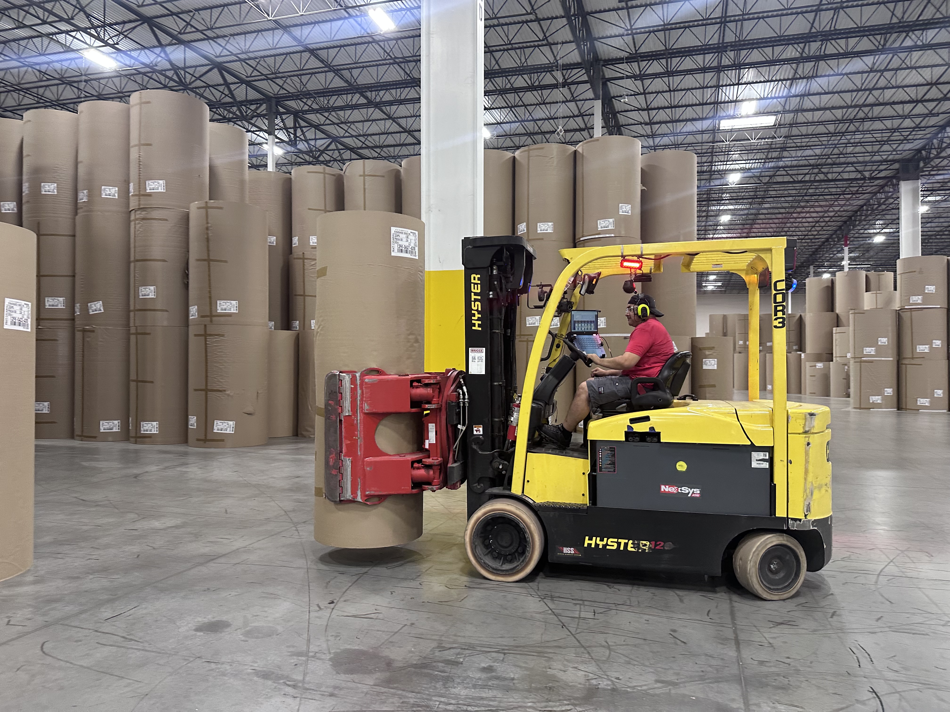 a man driving a forklift in a warehouse