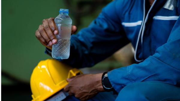 a person holding a bottle of water