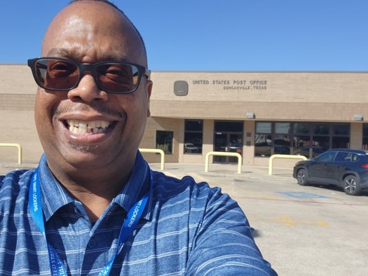 a man wearing sunglasses and smiling