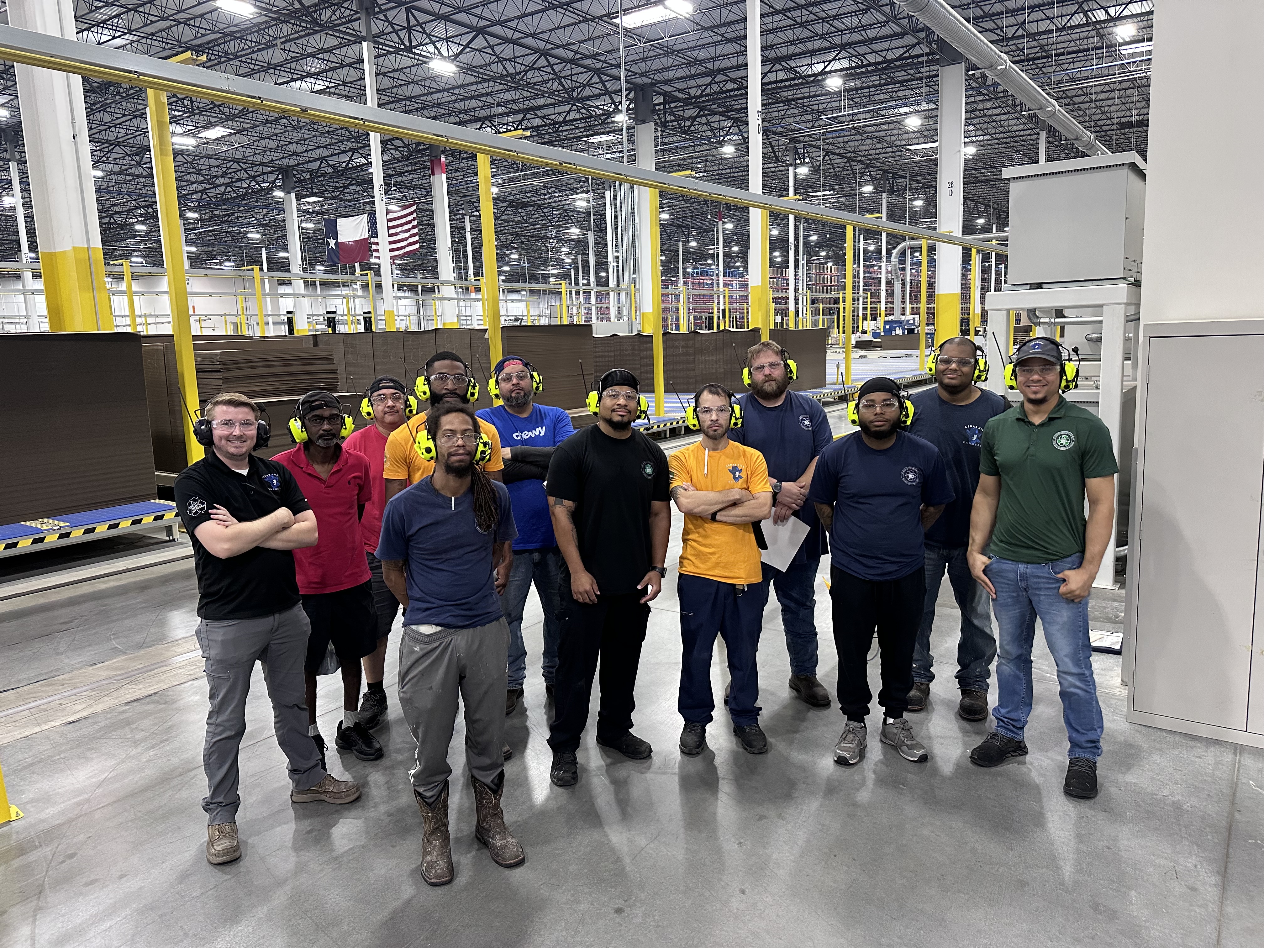 a group of men standing in a factory