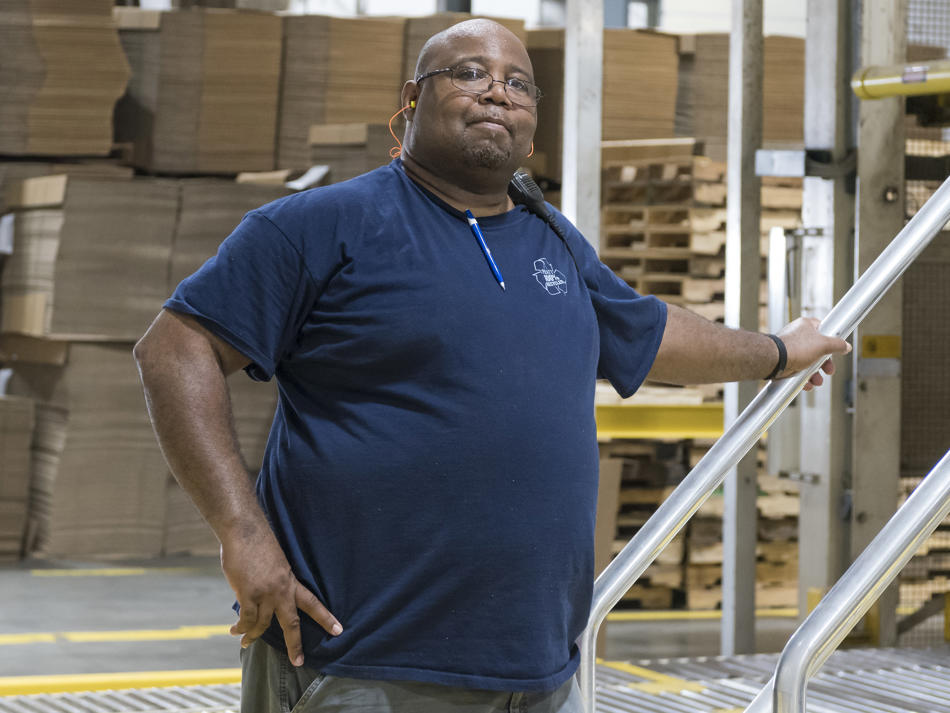 a man standing on a staircase in a warehouse