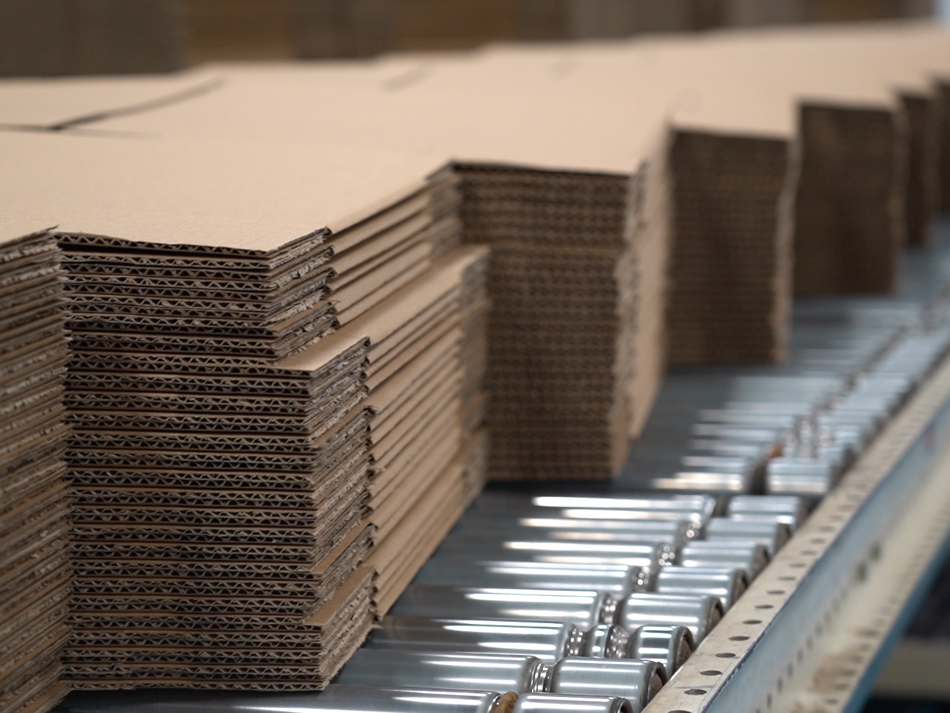 a stack of cardboard boxes on a conveyor belt