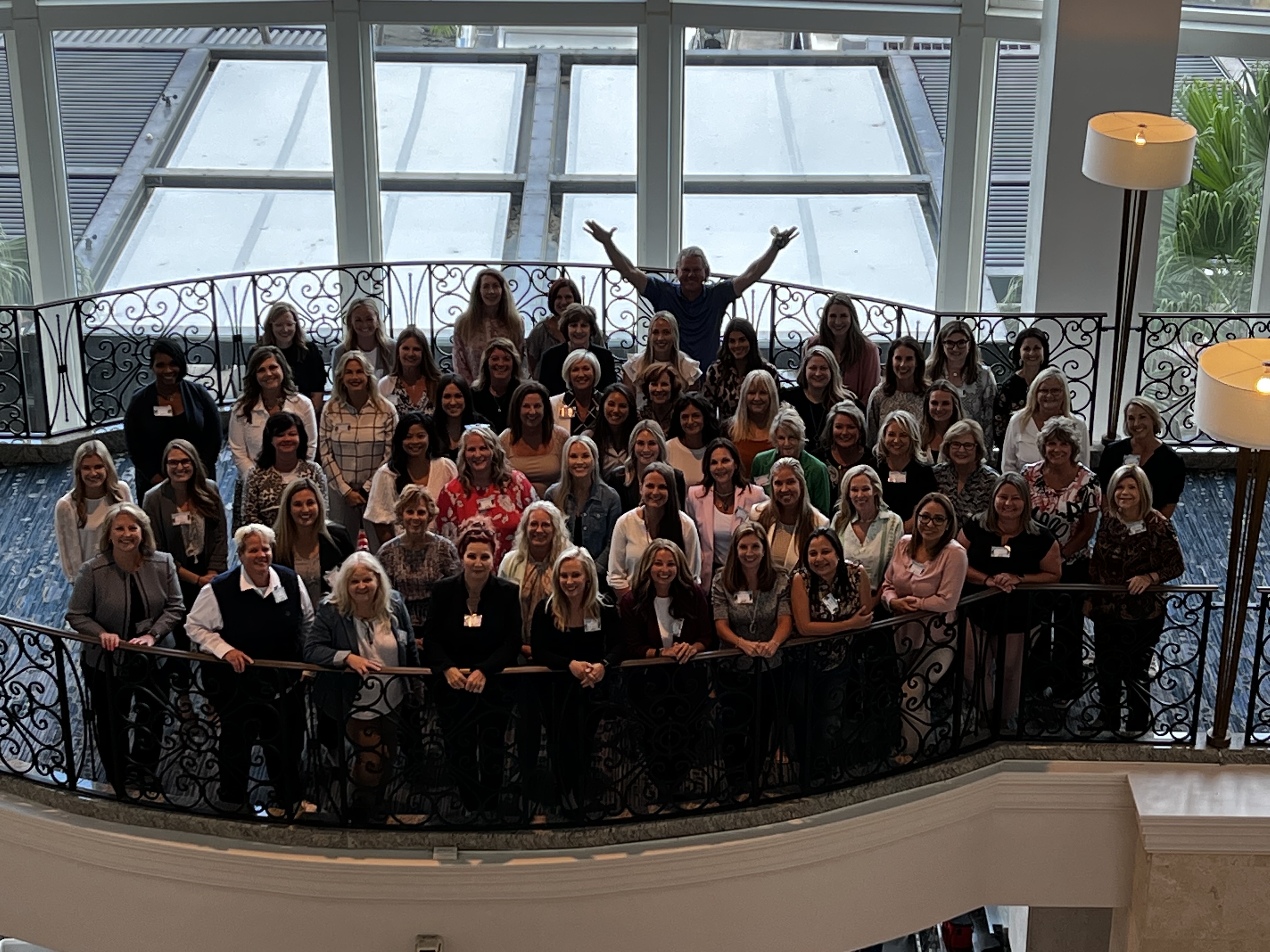 a group of women standing on a balcony