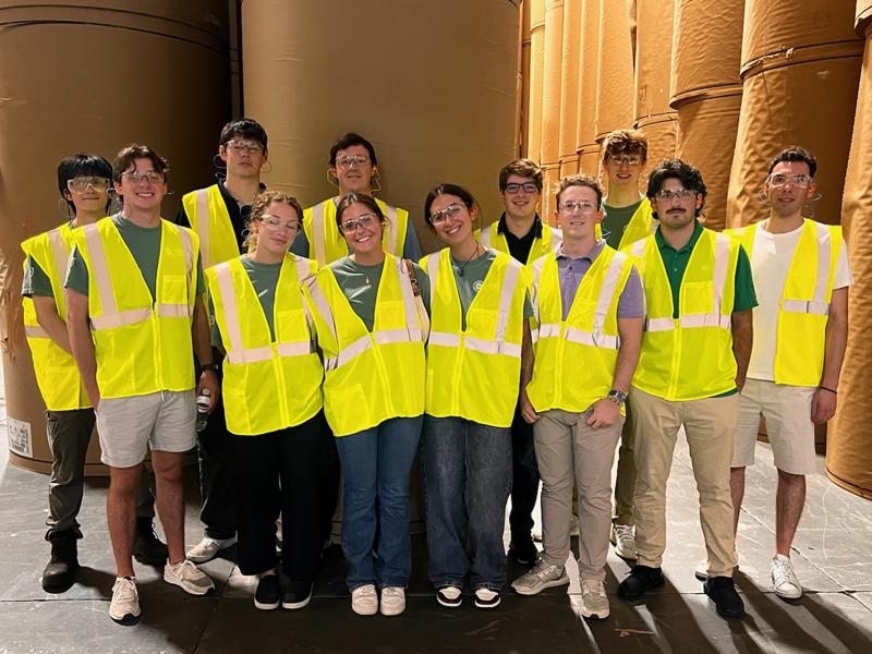 a group of people in yellow vests